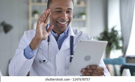 Online Video Chat on Tablet by African-American Doctor