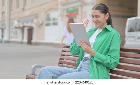 Online Video Chat On Tablet By Hispanic Woman Sitting Outdoor