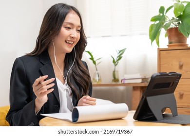 Online Video Communication, Attractive Asian Young Woman In Formal Suit, Using Tablet Having Online Virtual Job Interview Meeting Conversation On Video Call, Distance Remote Recruitment Conference.