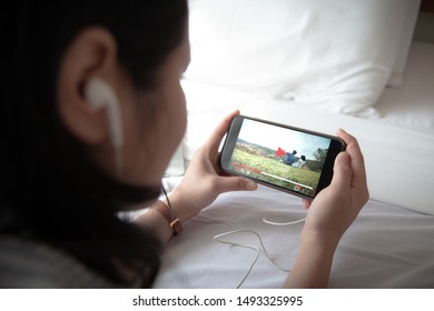 Online Video ondemand streaming concept.Female hands holding mobile phone. - Shutterstock ID 1493325995