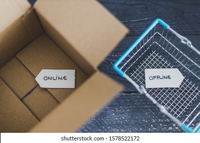 Online Vs Retail Shopping Conceptual Still-life, Parcel And Shopping Basket With Online And Offline Signs