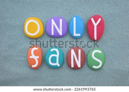 Only Fans, creative message composed with multi colored stone letters over green sand