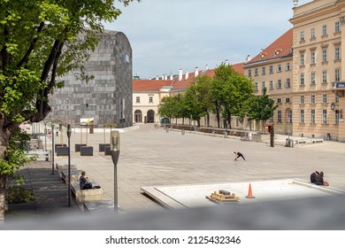 Only a few people enjoy a sunny afternoon at the Museumsquartier in Vienna during a lockdown 2020. It is the eighth largest cultural area in the world with museums, arts, architecture, music, fashion