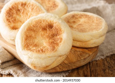 Only From The Oven English Muffin Buns Close-up On A Wooden Board On The Table. Horizontal
