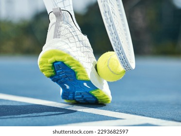 Only professionals pick up tennis balls this way. Cropped shot of an unrecognisable man using his foot and racket to pick up a tennis ball during practice. - Powered by Shutterstock