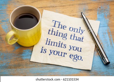 The only thing that limits you is your ego - handwriting on a napkin with a cup of espresso coffee