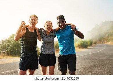 Only Those Who Persevere Will Become Victorious. Portrait Of A Group Of Sporty Young People Celebrating After A Workout Outside.