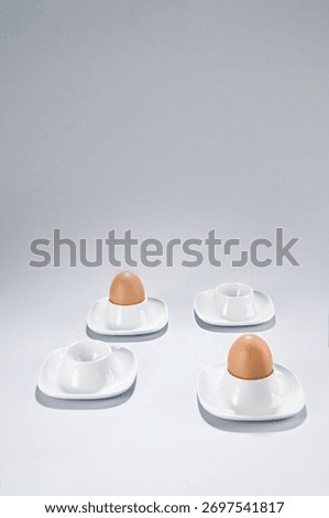 Only two eggs in an eggcups and two more are empty. Copy space, vertical.