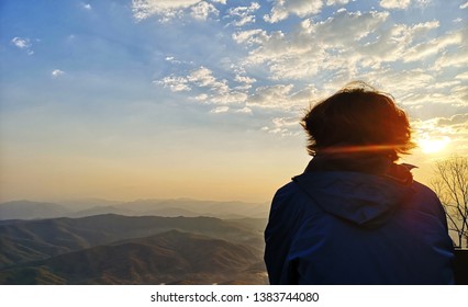 Only woman sitting watching the sunset,beautiful landscape - Shutterstock ID 1383744080