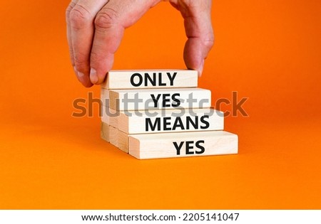 Only yes means yep symbol. Concept words Only yes means yes on wooden blocks on a beautiful orange table orange background. Businessman hand. Business, psychological only yes means yep concept.