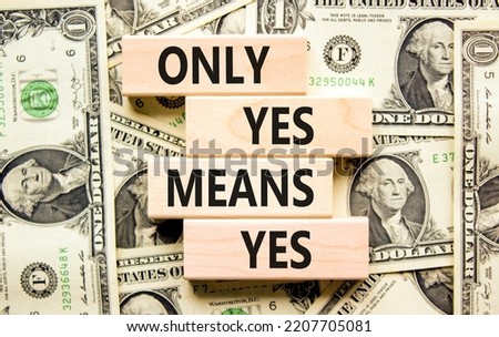 Only yes means yep symbol. Concept words Only yes means yes on wooden blocks on a beautiful background from dollar bills. Business, psychological only yes means yep concept.