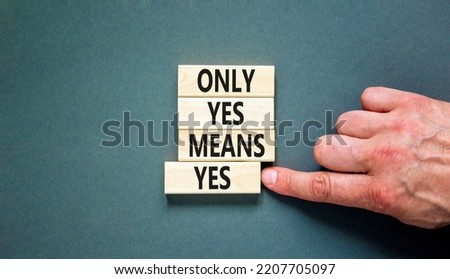 Only yes means yep symbol. Concept words Only yes means yes on wooden blocks on a beautiful grey table grey background. Businessman hand. Business, psychological only yes means yep concept.