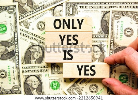 Only yes is yes symbol. Concept words Only yes is yep on wooden blocks on a beautiful background from dollar bills. Businessman hand. Business, psychological only yes is yep concept.