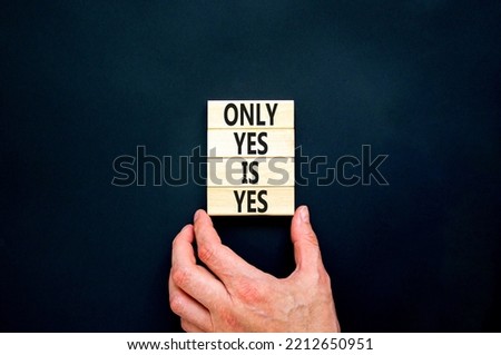 Only yes is yep symbol. Concept words Only yes is yes on wooden blocks on a beautiful black table black background. Businessman hand. Business, psychological only yes is yep concept.