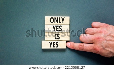 Only yes is yep symbol. Concept words Only yes is yes on wooden blocks on a beautiful grey table grey background. Businessman hand. Business, psychological only yes is yep concept.