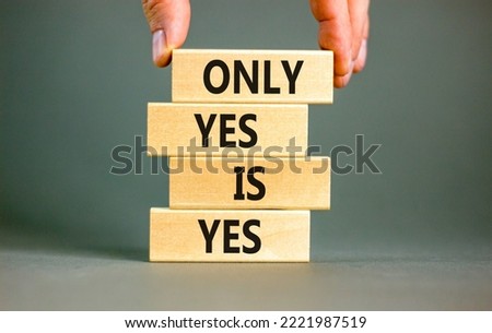 Only yes is yep symbol. Concept words Only yes is yes on wooden blocks on a beautiful grey table grey background. Businessman hand. Business, psychological only yes is yep concept.