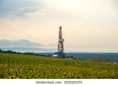 Onshore Drilling Rig For Oil And Gas Production. Gas Production Station Tower In The Fields, Industry Mining