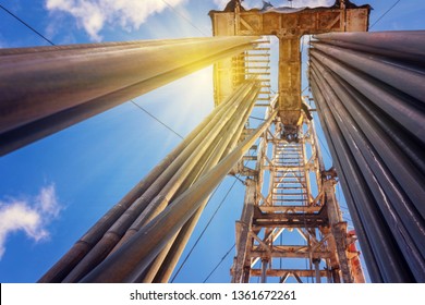 Onshore land rig in oil and gas industry. Oil drilling rig against a blue sky with clouds