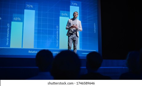 On-Stage: Speaker Does Presentation Of The New Electronic Product, Shows Infographics, Statistic Animation On Screen. Auditorium Hall Live Event, Start-up Conference, Device Presentation And Release