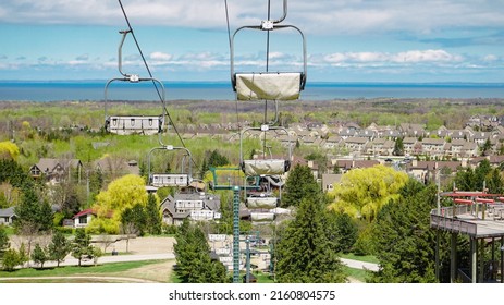 Ontario Blue Mountains peak. City and sea view behind the cable cars. - Powered by Shutterstock