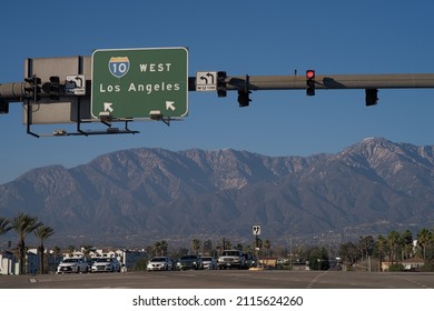 Ontario, California, USA - January 30, 2022: image of a sign indicating the Interstate 10, I-10, highway shown with the San Gabriel Mountains in the background. 