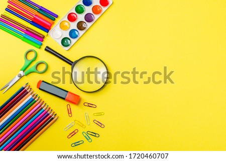ools for creativity on a colored background. Watercolor paint. Colored paints and pencils. Back to school. The concept of children's painting. Art. View from above. Space for an inscription. Statione