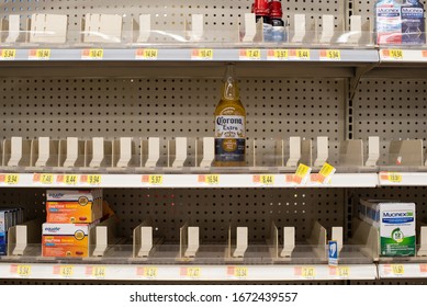 Ooltewah, Tennessee, USA, 3.14.2020 : Medicine Shelves At The Ooltewah, TN Walmart Are Nearly Bare But A Practical Joker Took The Time To Put A Corona Beer Bottle In The Empty Racks.  