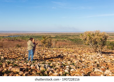 Oombulgurri, WA, Australia - Sep 2, 2014: An  Australian Indigenous Community Leader Explain Landscape Features To Adventure Travellers On The Carson River Track.