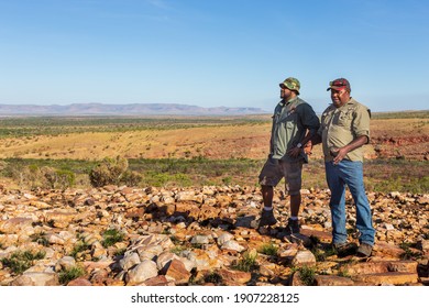 Oombulgurri, WA, Australia - Sep 2, 2014: Two Australian Indigenous Community Leaders Explain Landscape Features To Adventure Travellers On The Carson River Track.