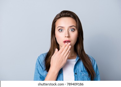 Oops . Close Up Portrait Of Young, Cute, Pretty Excited, Funky Manager With Wide Opened Eyes Holding  Hands Near Mouth   Standing Over Grey Background