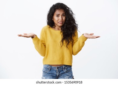 Oops girl says sorry. Cute silly african american woman, curly black hair, shrugging hands spread sideways, frowning and crying as feeling worried, apologizing making mistake, stand white background - Shutterstock ID 1535690918