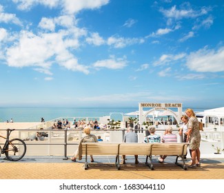 Oostende, Belgium, June 2016 - People Talking Sitting In A Bench In Front Of Bondi Beach Bar In Oostende, Belgium In A Summer Afternoon.