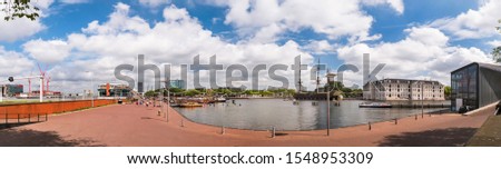 Oosterdock, Eastern dock panorama view with the Nemo Science Museum in the background. Amsterdam, the Netherlands cityscape