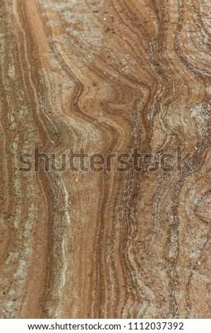 A ooze pattern on sandy beach. Wet sand of a lake shore.