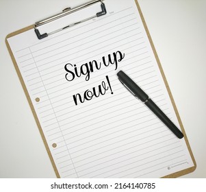 op view of pen and paper with text SIGN UP NOW! on the clipboard. Business and education concept. - Powered by Shutterstock