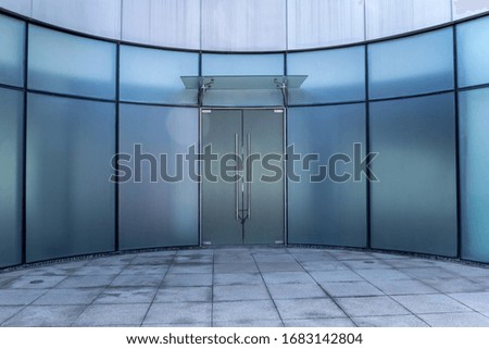 Opaque building with blue glass doors