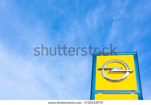 Opel brand logo on bright blue sky\
background located in Lyon, France - February 23,\
2020