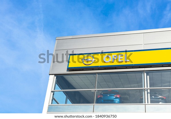 Opel\
brand logo on bright blue sky background located on its dealer\
office building in Lyon, France - February 23,\
2020