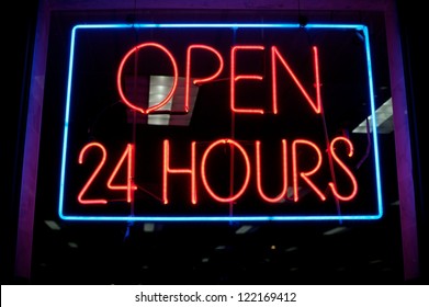 Open 24 Hours Neon Sign In A Store Window