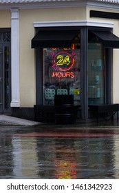 Open 24 Hours Neon Sign On A Restaurant Window With Italian Awnings. Summer Rainy Evening. Streetfood Concept. Copyspace For Cafe Name. Vertical Photo