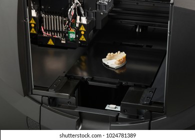 Open 3D Printer With Finished 3D Printed Dental Implant Bridge.