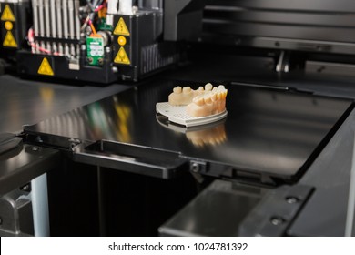 Open 3D Printer With Finished 3D Printed Dental Implant Bridge.