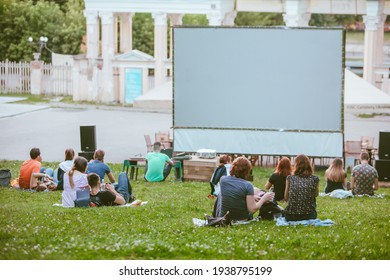 Open Air Cinema Concept. People Watching Movie In City Public Park. Copy Space