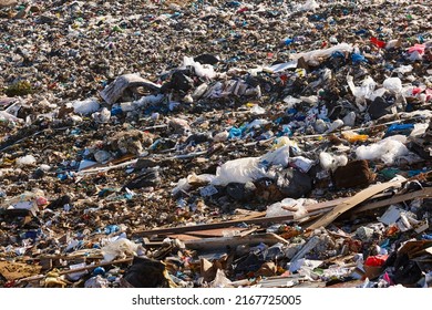 Open air garbage dump. Plastic pollution. Recycling junk. Consumerism - Shutterstock ID 2167725005