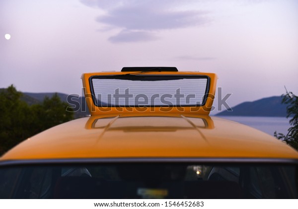open back trunk of taxi station wagon car on\
background sky in dusk