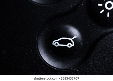 The open baggage icon button is close on the digital car key device. Old and dirty