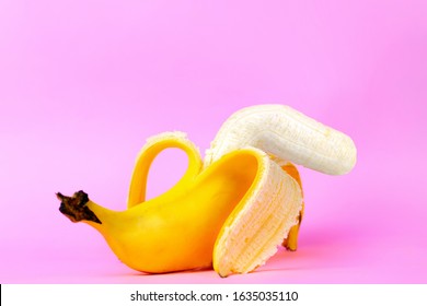 An Open Banana Symbolizing The Male Sexual Organ In An UN-erect State Or Impotence. Pink Background. Concept Of Potency And Men's Health And Power. Copy Soace