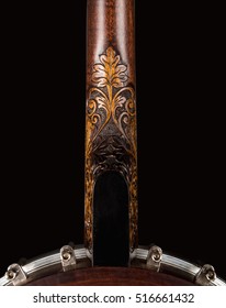Open Banjo on black background. Carved wooden neck Benjo. Beautiful carved painting.