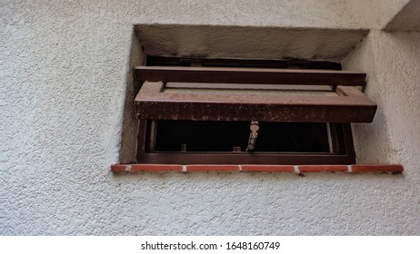 Open Bathroom Window From Outside The House, White Wall And Red Tiles