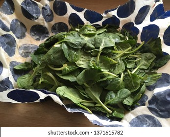 Open Beeswax Food Wrap With Bunch Of Fresh Spinach